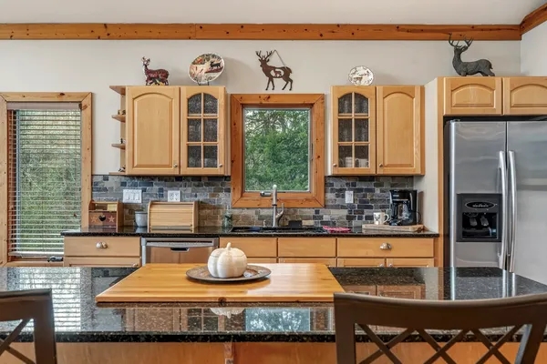 a kitchen with stainless steel appliances granite countertop sink stove and cabinets