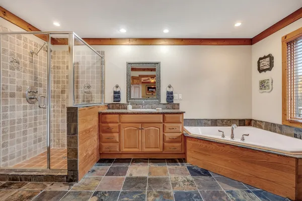 a bedroom with a bed a window and a chandelier