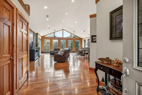 a view of a livingroom with wooden floor and furniture