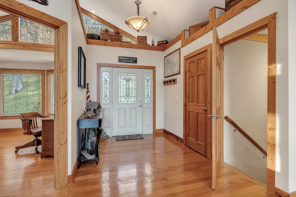 a living room with furniture fireplace and wooden floor