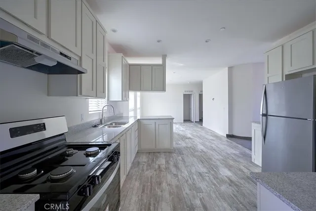 a kitchen with a stove a sink and a refrigerator