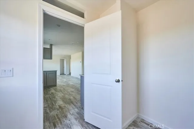 a view of a room with wooden floor