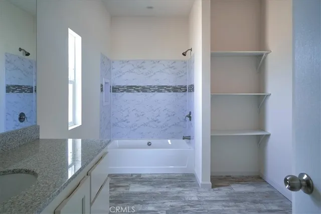a bathroom with a bathtub and a shower