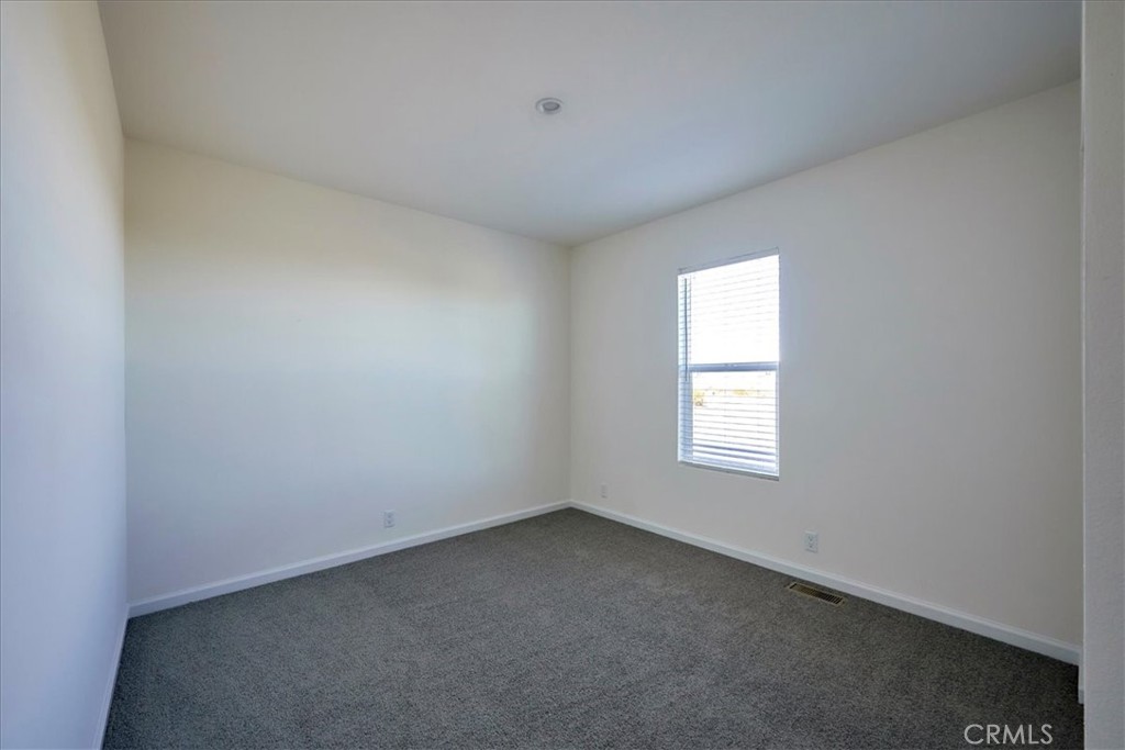 13358 Buttonwood Street Phelan, CA 92371 - Photo 27 of 33 an empty room with a window