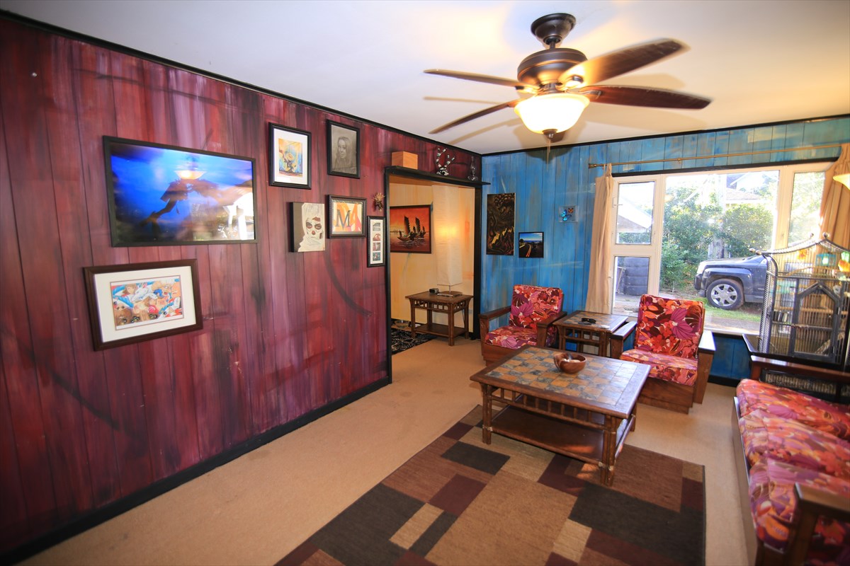3378 Hailima Road Koloa, HI 96756 - Photo 3 of 8 a living room with furniture a chandelier and a painting
