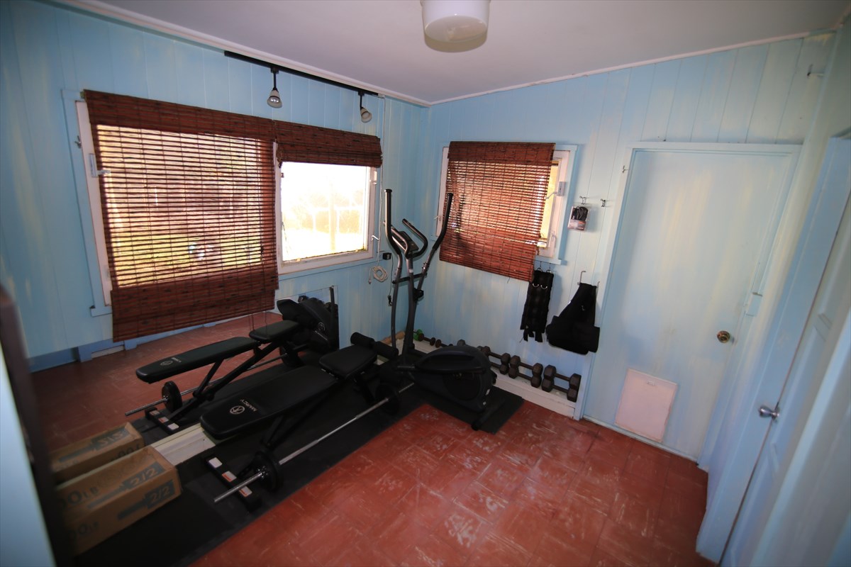 3378 Hailima Road Koloa, HI 96756 - Photo 5 of 8 a room with gym equipment and a large window