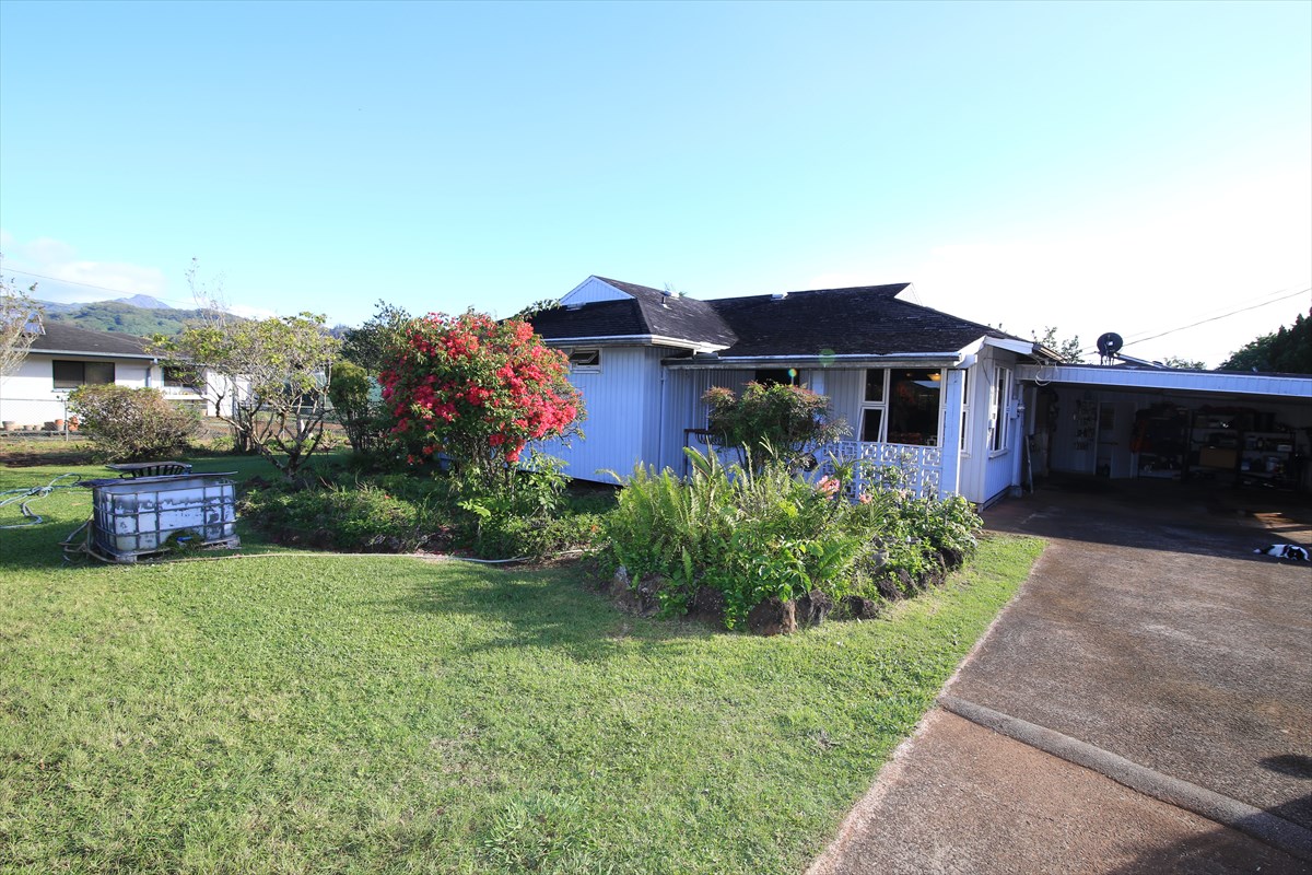 3378 Hailima Road Koloa, HI 96756 - Photo 6 of 8 a front view of a house with a garden and yard
