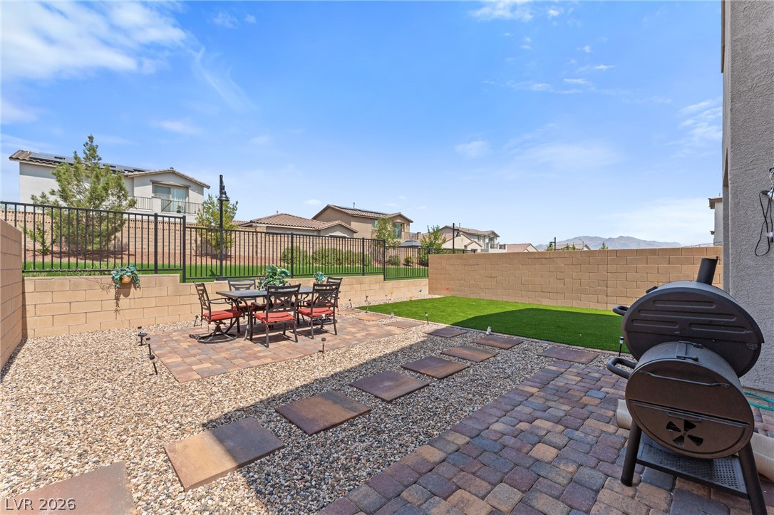 8879 Roadrunner Ravine Street Las Vegas, NV 89166 - Photo 36 of 39 A low-maintenance backyard retreat provides ample space for relaxation and entertaining.