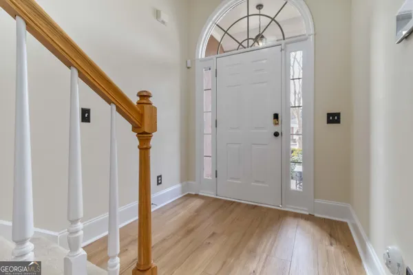a view of a livingroom with furniture and a hallway