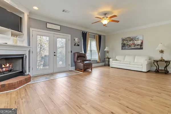 a living room with furniture a fireplace and a flat screen tv