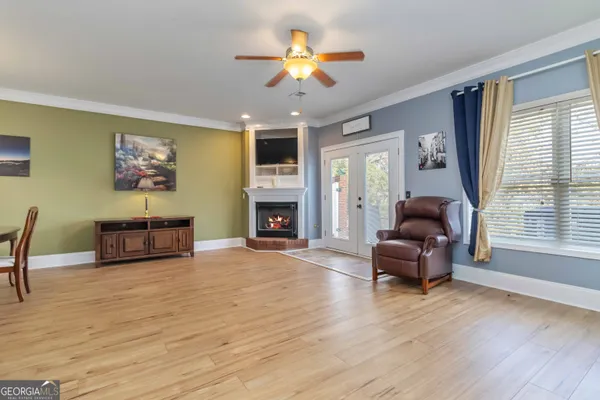 a kitchen with granite countertop a stove a sink dishwasher and cabinets with wooden floor