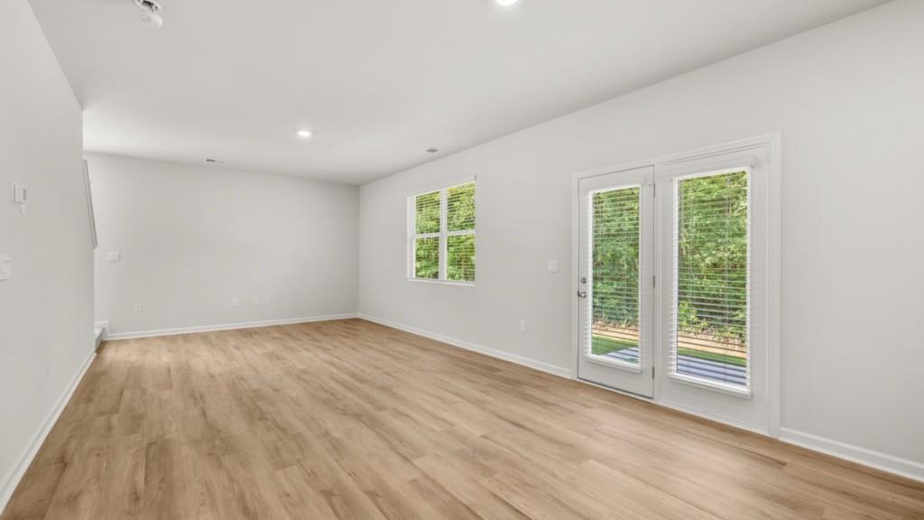 517 Oak View Lane Dallas, GA 30157 - Photo 12 of 41 an empty room with wooden floor and windows