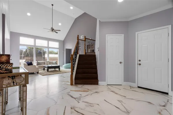a view of a livingroom with furniture and stairs