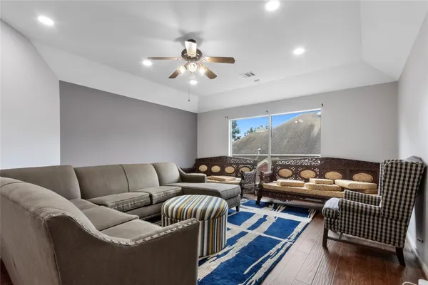 a living room with furniture and wooden floor