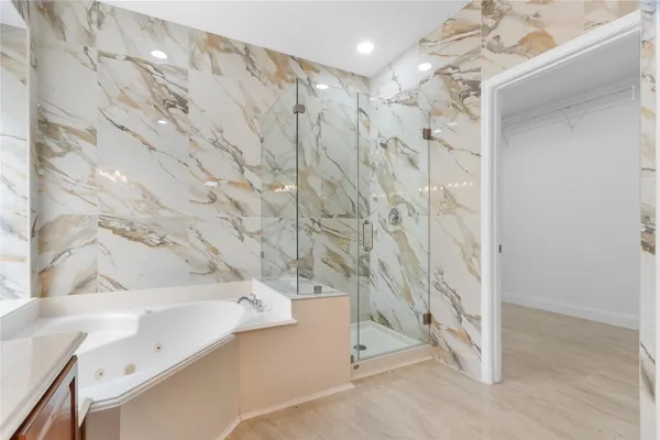 a bathroom with a bathtub and shower