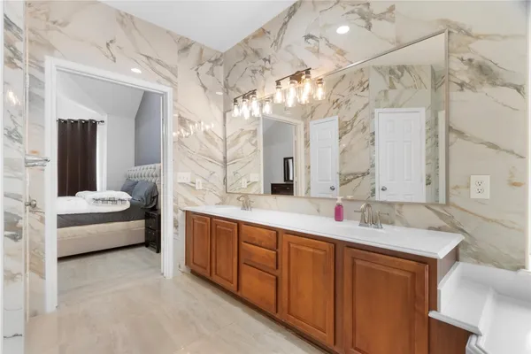 a spacious bathroom with a double vanity sink mirror and double