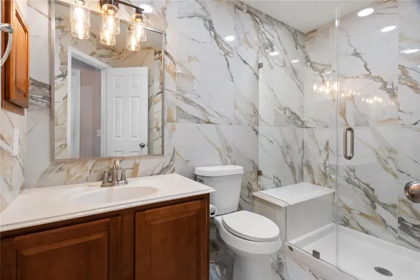 a bathroom with a sink toilet and shower