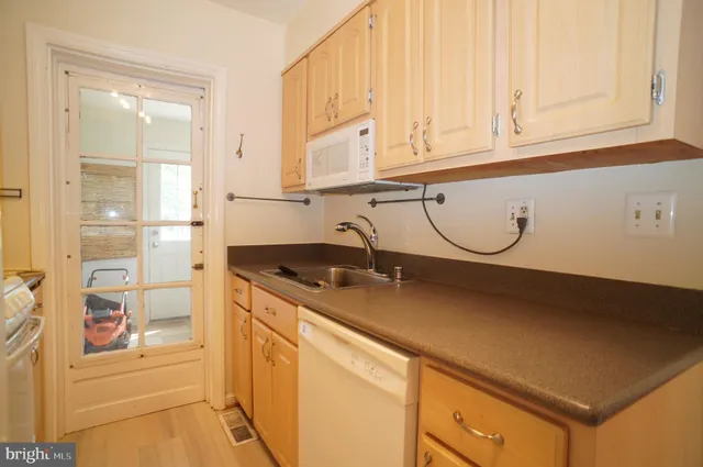a kitchen with granite countertop a sink and a stove top oven