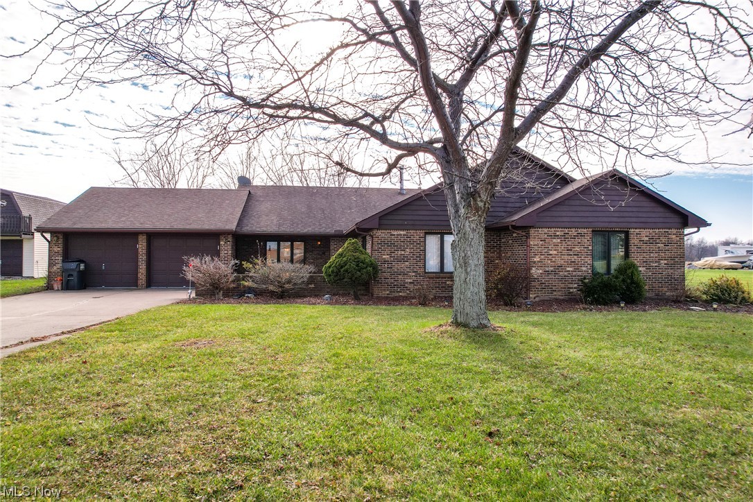 13920 Kneisel Road Vermilion, OH 44089 - Photo 1 of 35 Ranch-style house with a garage and a front lawn
