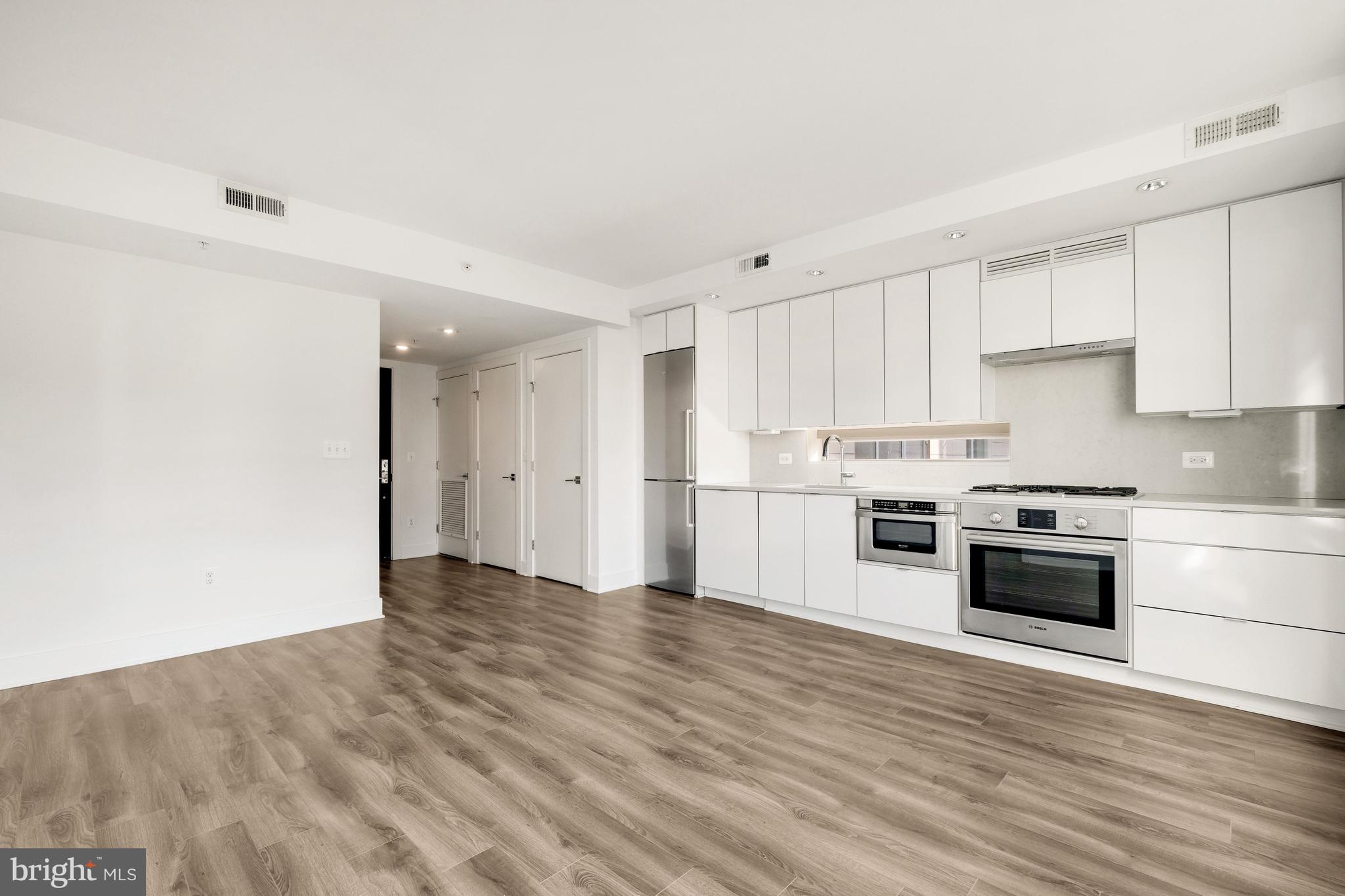 1311 13th Street Northwest, Unit 409 Washington, DC 20005 - Photo 11 of 25 a view of kitchen with wooden floor and electronic appliances