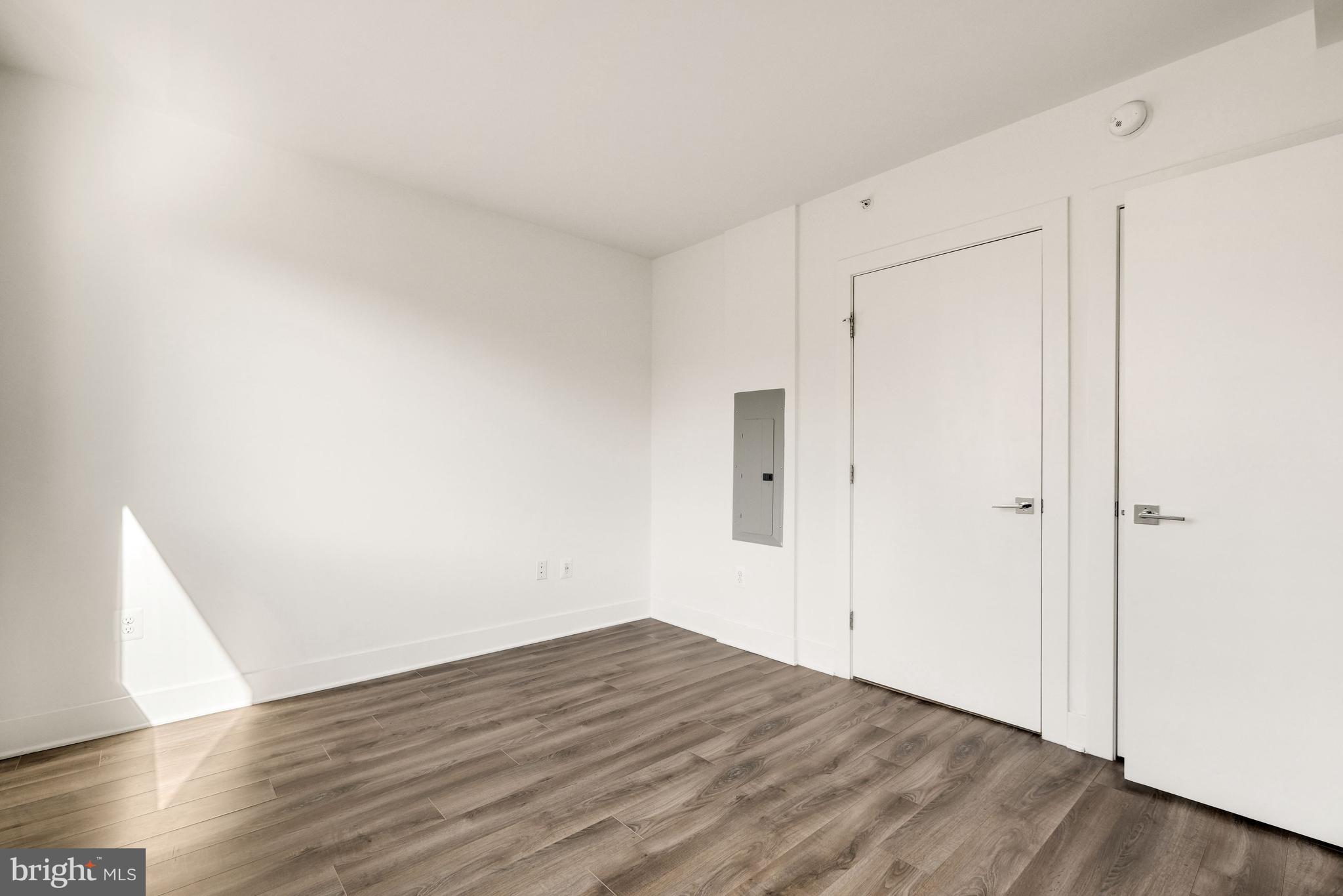 1311 13th Street Northwest, Unit 409 Washington, DC 20005 - Photo 16 of 25 a view of an empty room with wooden floor