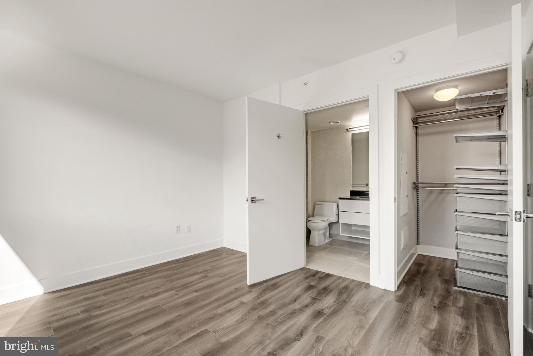 1311 13th Street Northwest, Unit 409 Washington, DC 20005 - Photo 17 of 25 a view of empty room with wooden floor