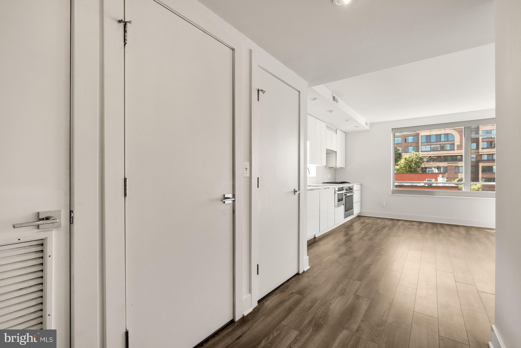 1311 13th Street Northwest, Unit 409 Washington, DC 20005 - Photo 5 of 25 a view of a hallway with wooden floor and a living room