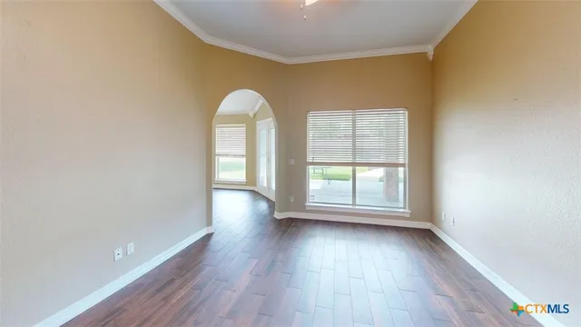 a kitchen with granite countertop stainless steel appliances a refrigerator stove top oven and sink