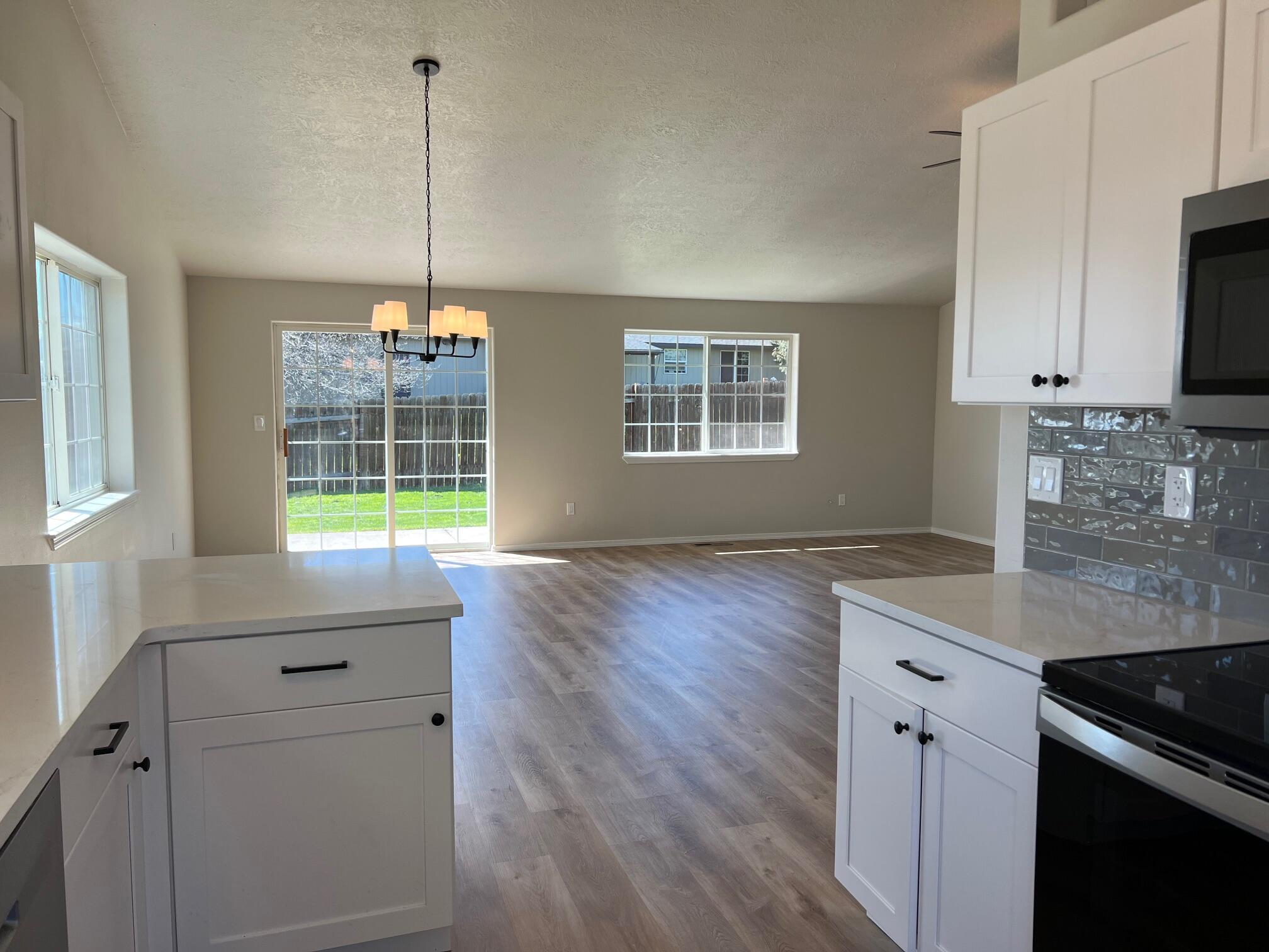 629 Deer Ridge Court Madras, OR 97741 - Photo 15 of 39 a kitchen with stainless steel appliances a sink stove and wooden floor