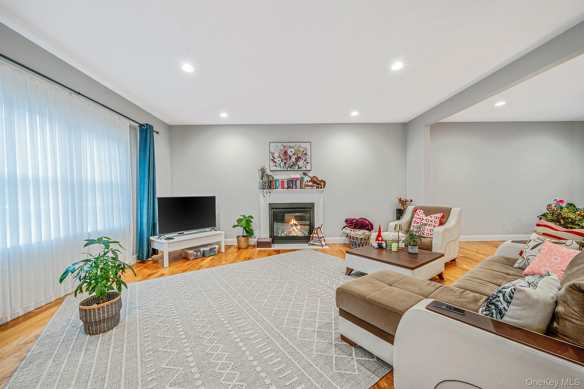 152 Wood Road Centereach, NY 11720 - Photo 12 of 35 a living room with furniture and a flat screen tv