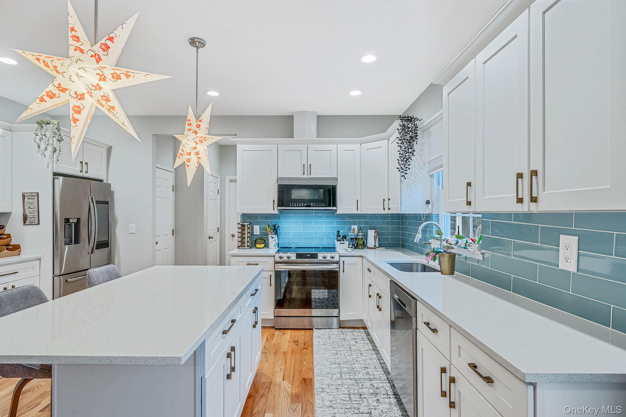152 Wood Road Centereach, NY 11720 - Photo 13 of 35 a kitchen with a sink a counter top stainless steel appliances and cabinets