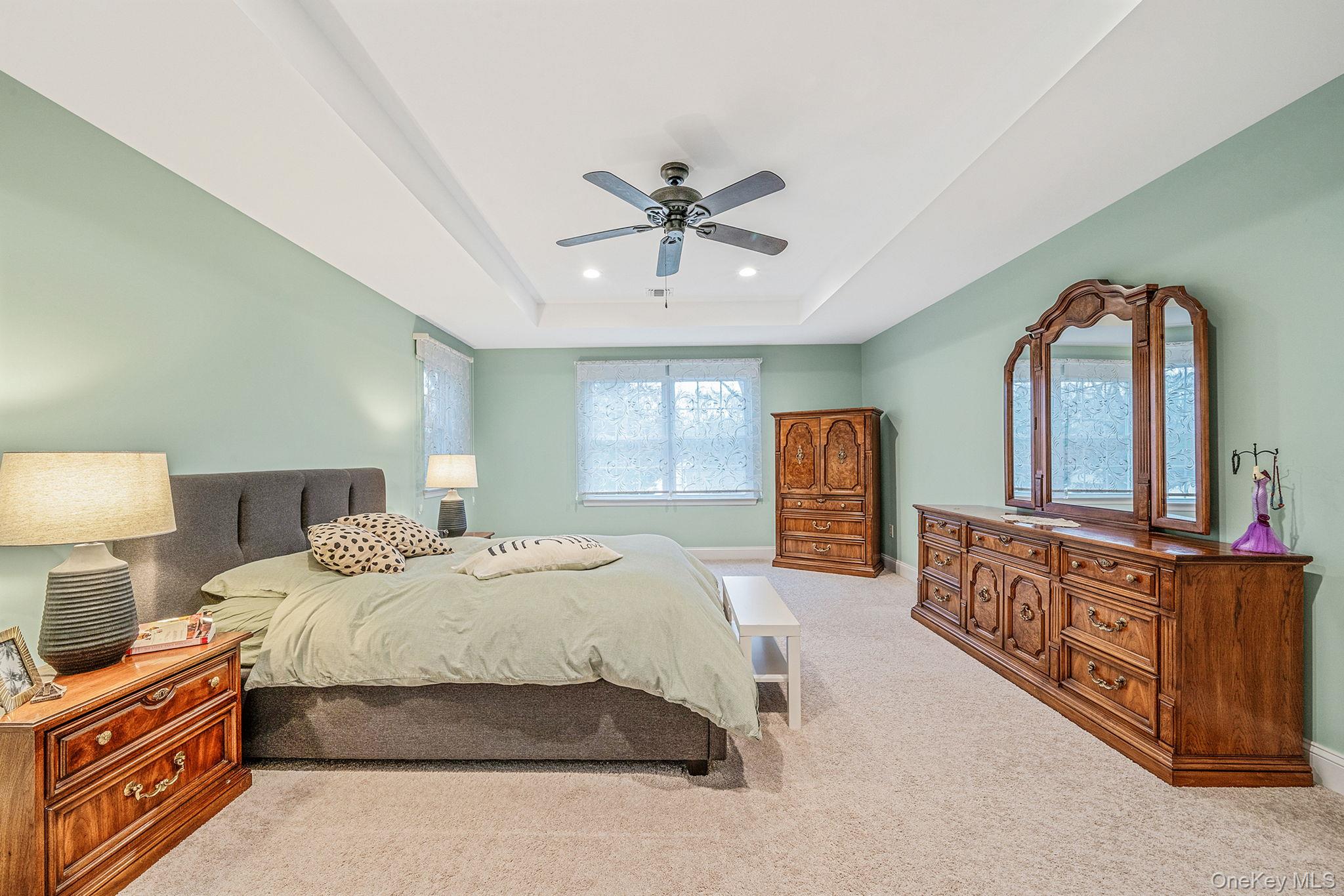 152 Wood Road Centereach, NY 11720 - Photo 19 of 35 a bedroom with a bed a dresser and dresser