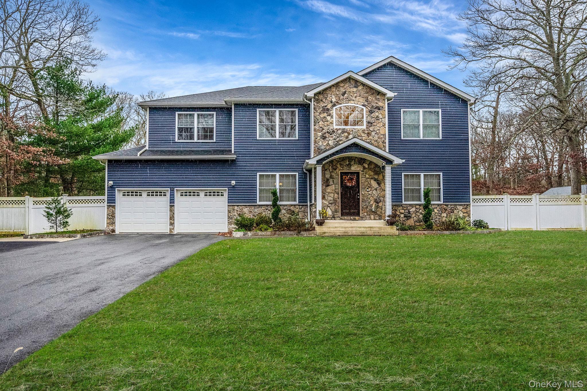 152 Wood Road Centereach, NY 11720 - Photo 2 of 35 a front view of a house with a yard