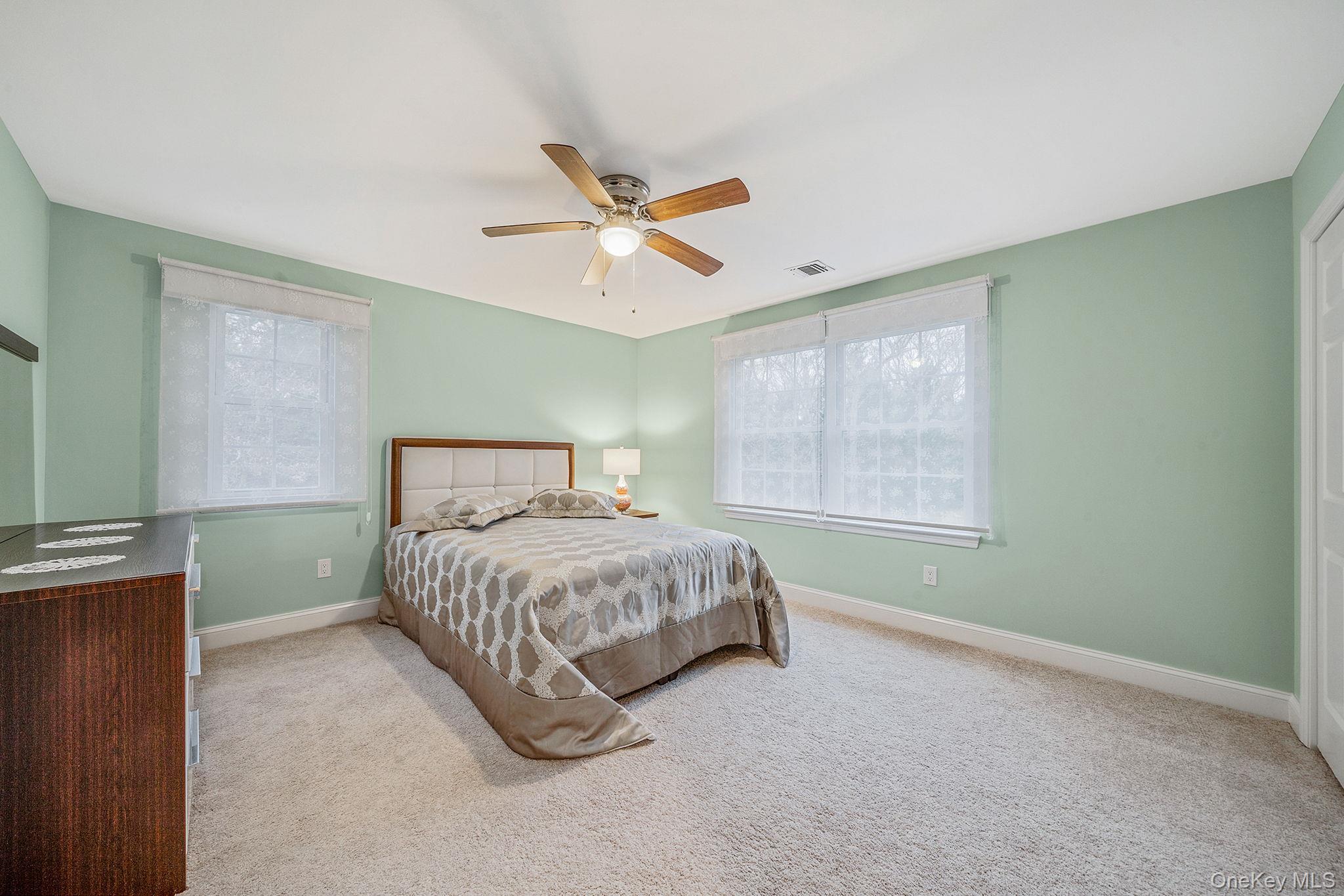 152 Wood Road Centereach, NY 11720 - Photo 23 of 35 a bedroom with a bed and a window