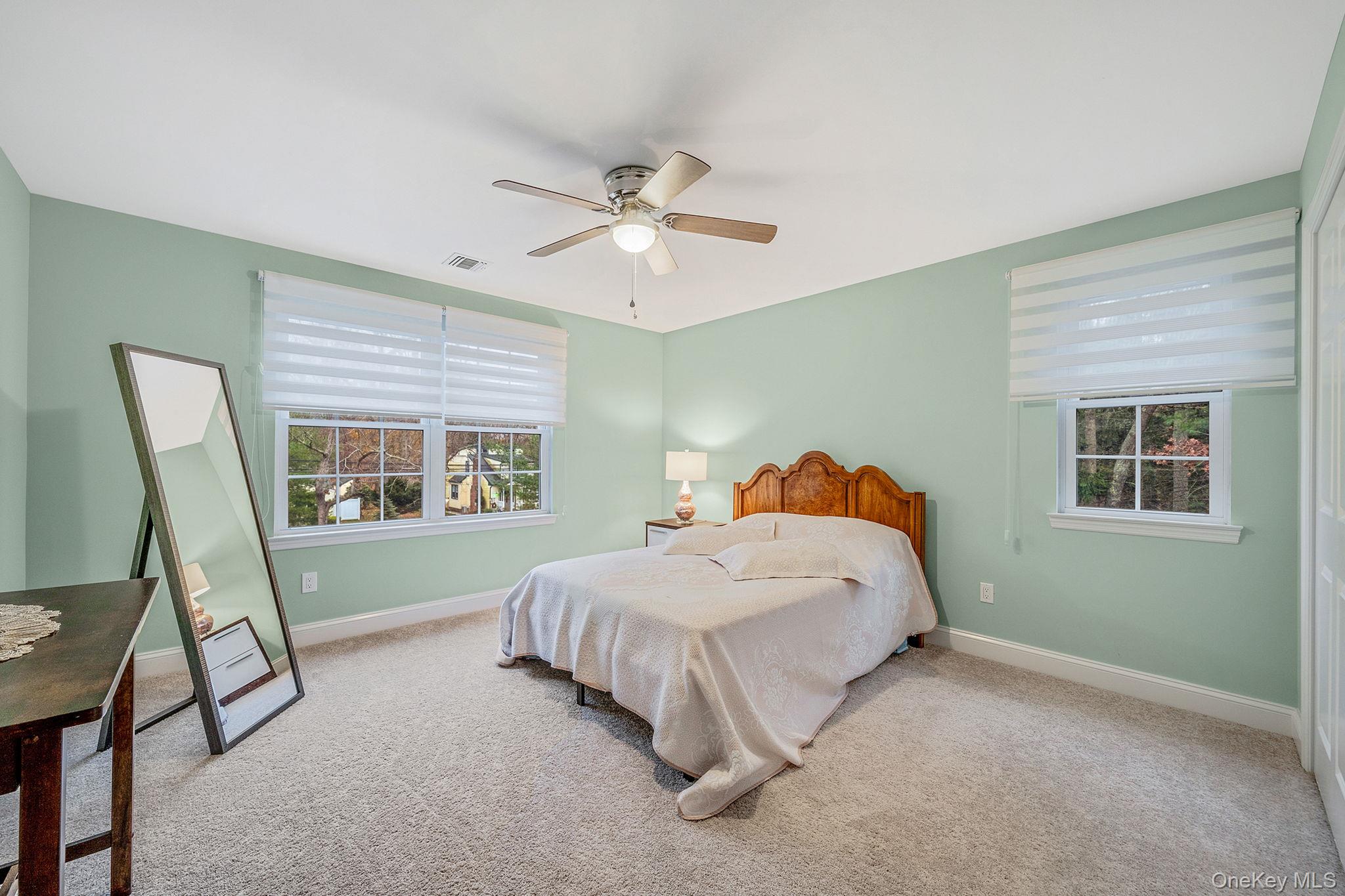 152 Wood Road Centereach, NY 11720 - Photo 24 of 35 a bedroom with a bed and a chandelier