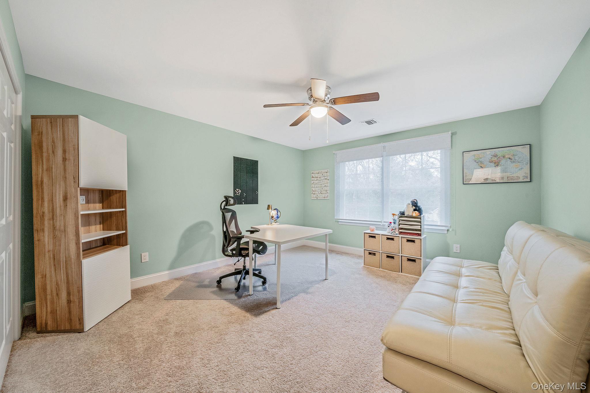152 Wood Road Centereach, NY 11720 - Photo 25 of 35 a view of a livingroom with workspace and a couch