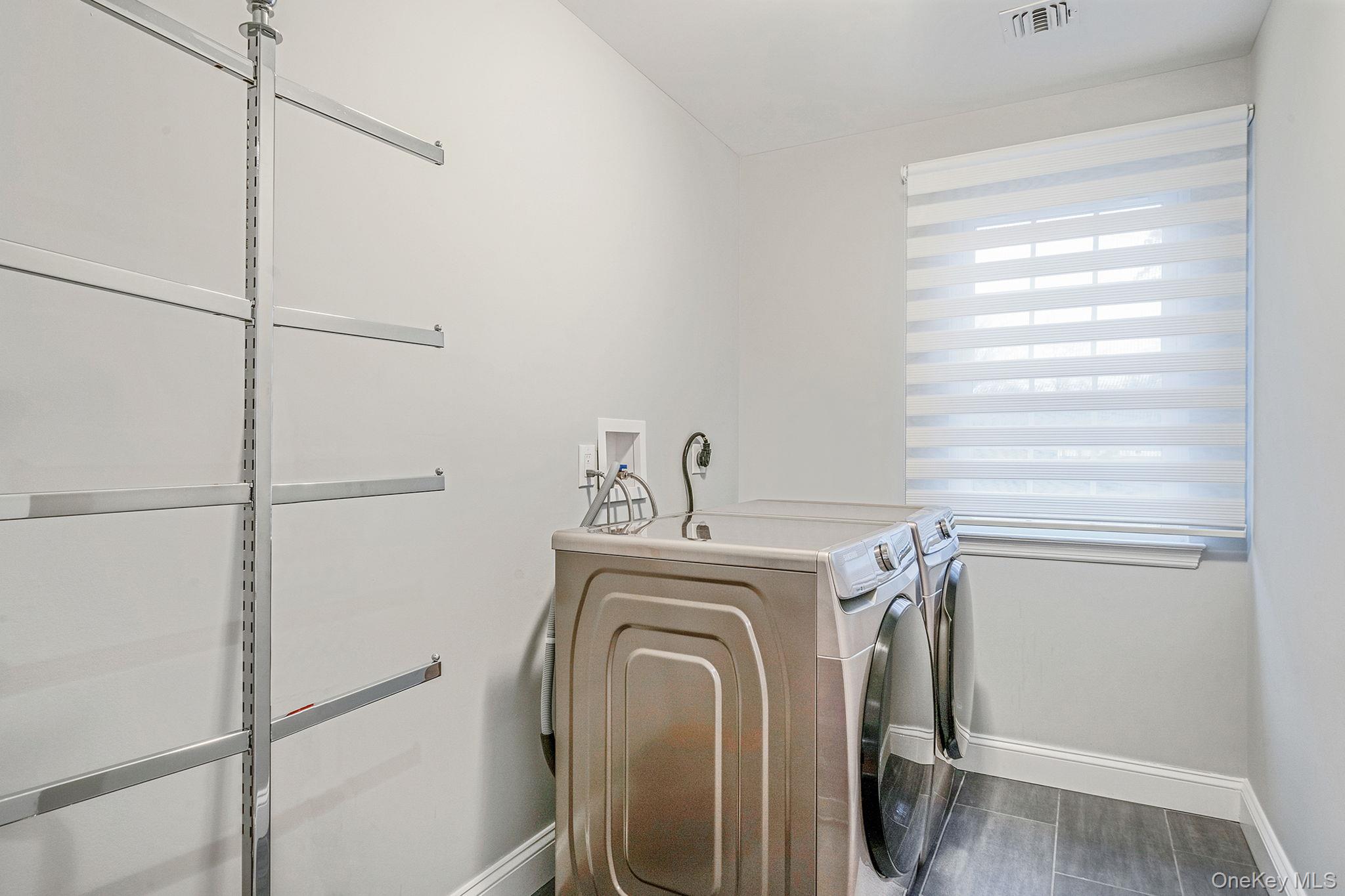 152 Wood Road Centereach, NY 11720 - Photo 27 of 35 a view of walk in closet with clothes and shoes