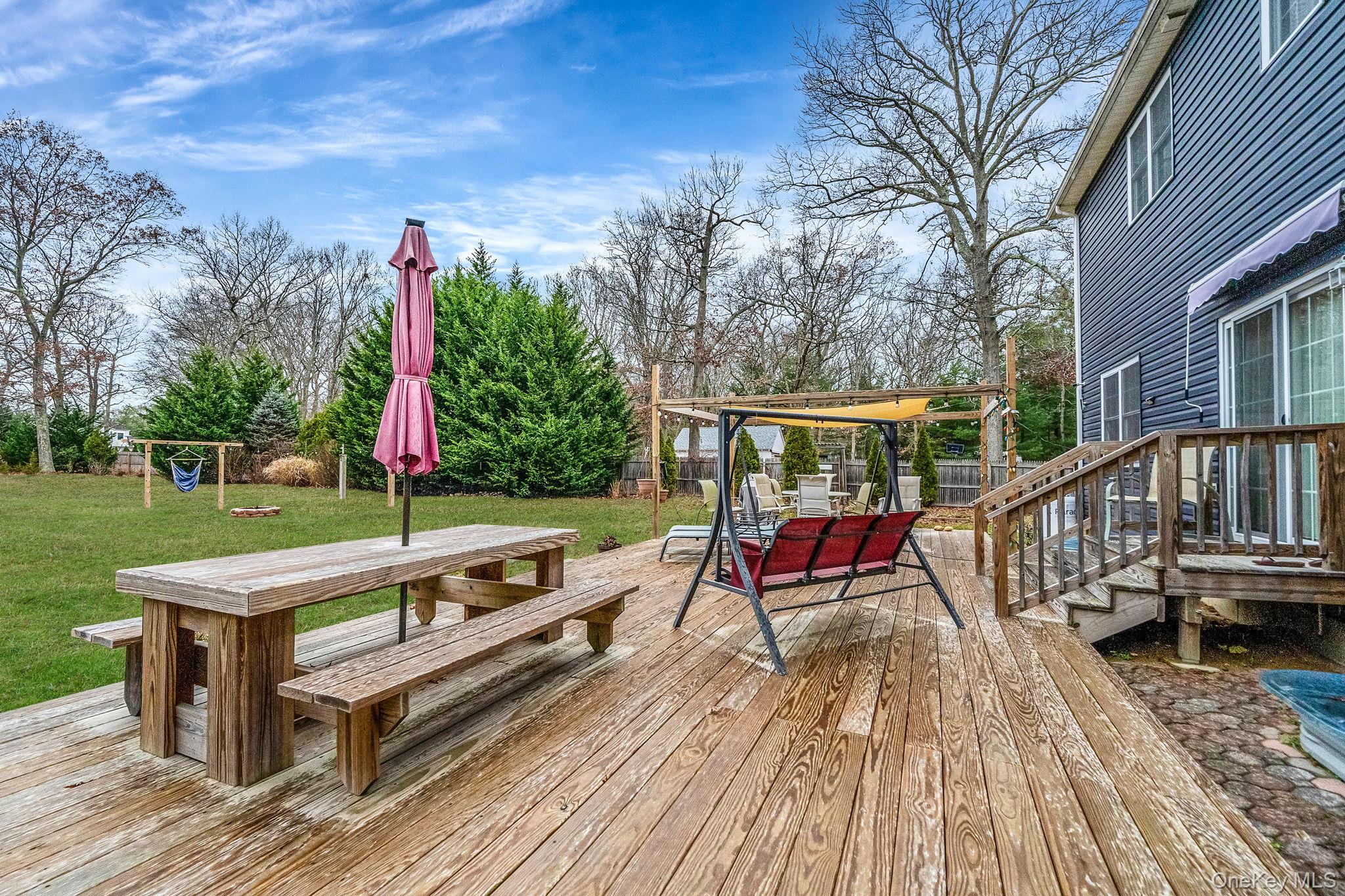 152 Wood Road Centereach, NY 11720 - Photo 30 of 35 a view of a deck with wooden floor and fence