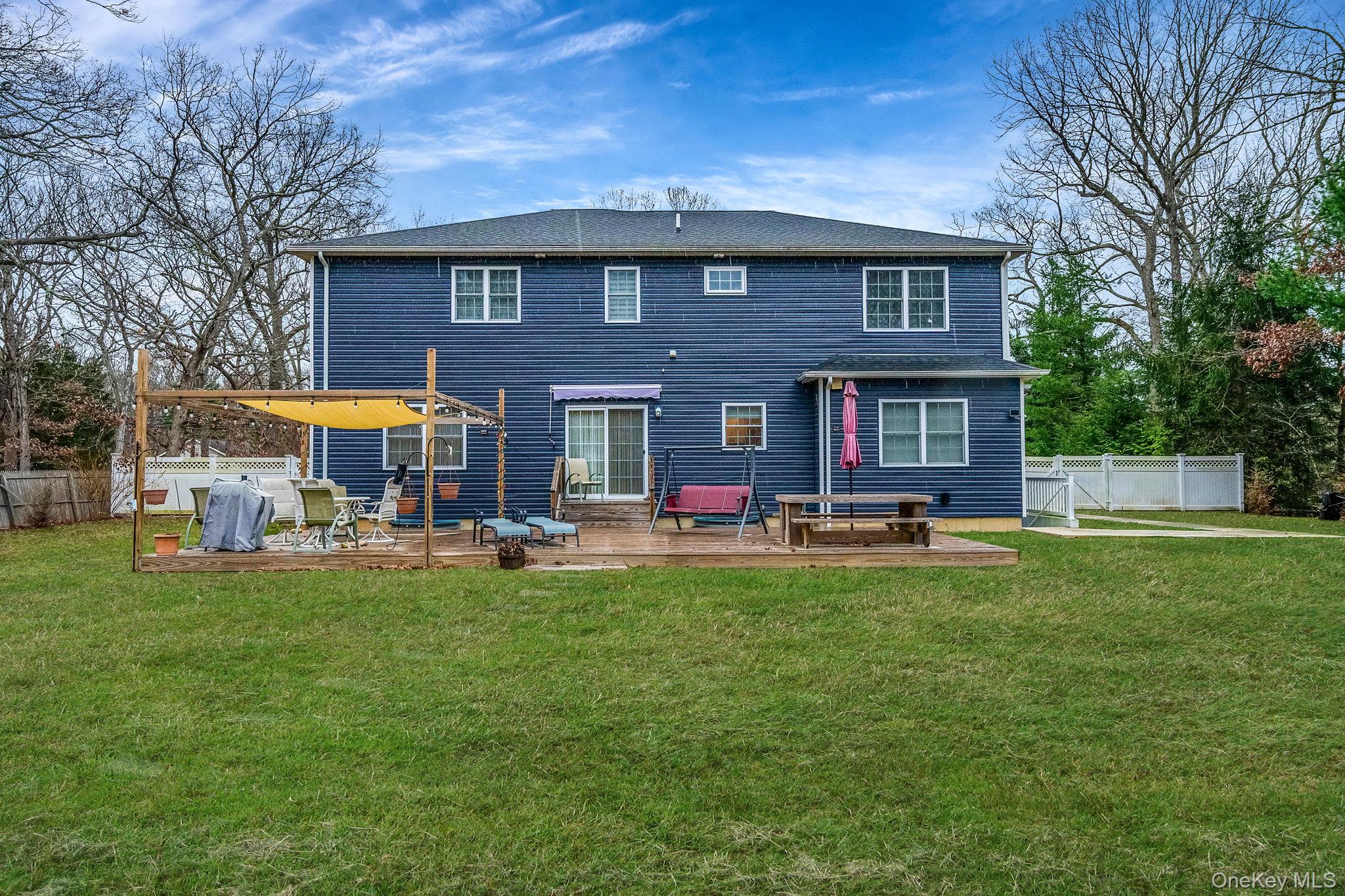 152 Wood Road Centereach, NY 11720 - Photo 32 of 35 a front view of a house with swimming pool having outdoor seating