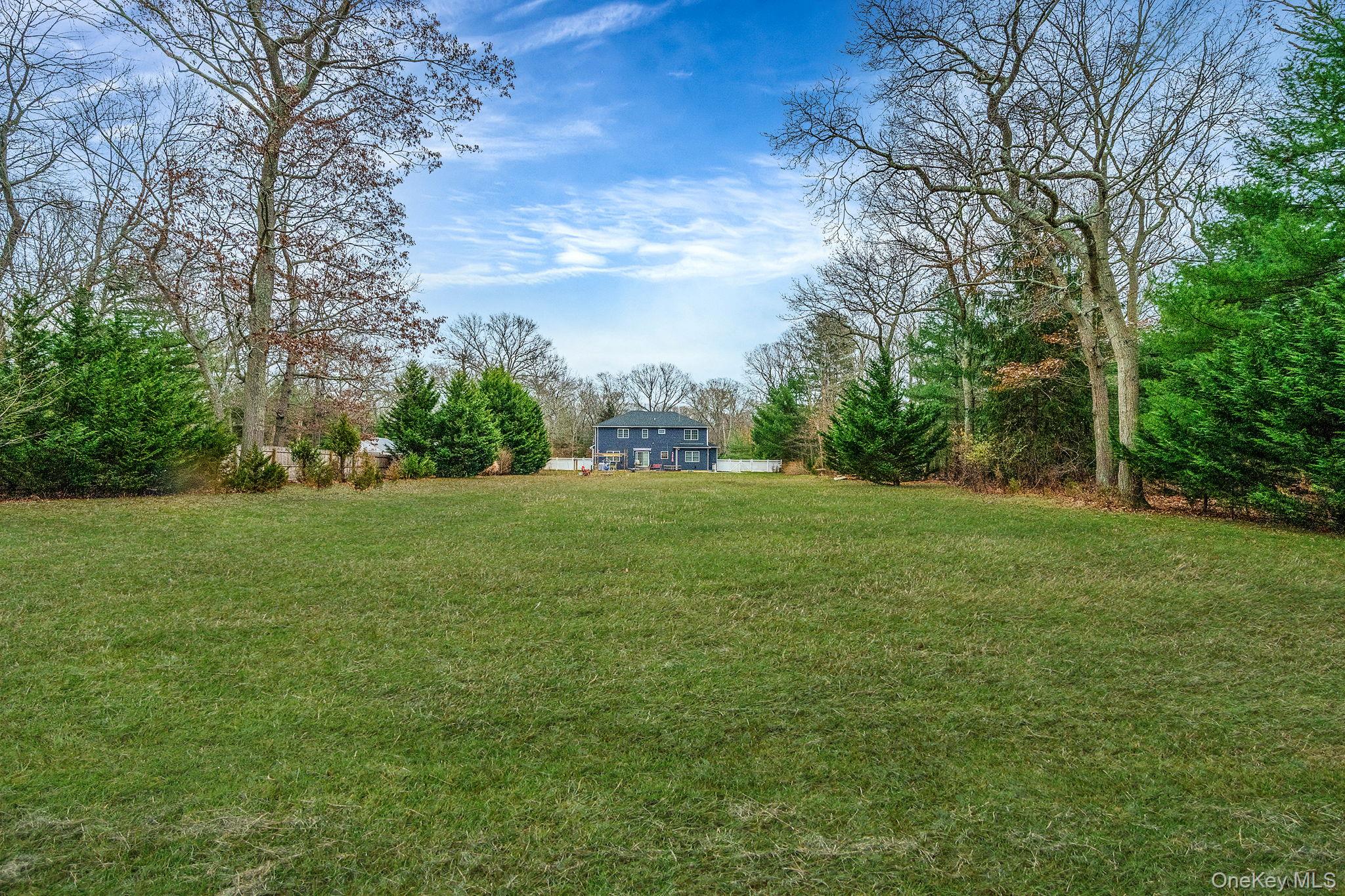 152 Wood Road Centereach, NY 11720 - Photo 33 of 35 a view of green field with trees in the background