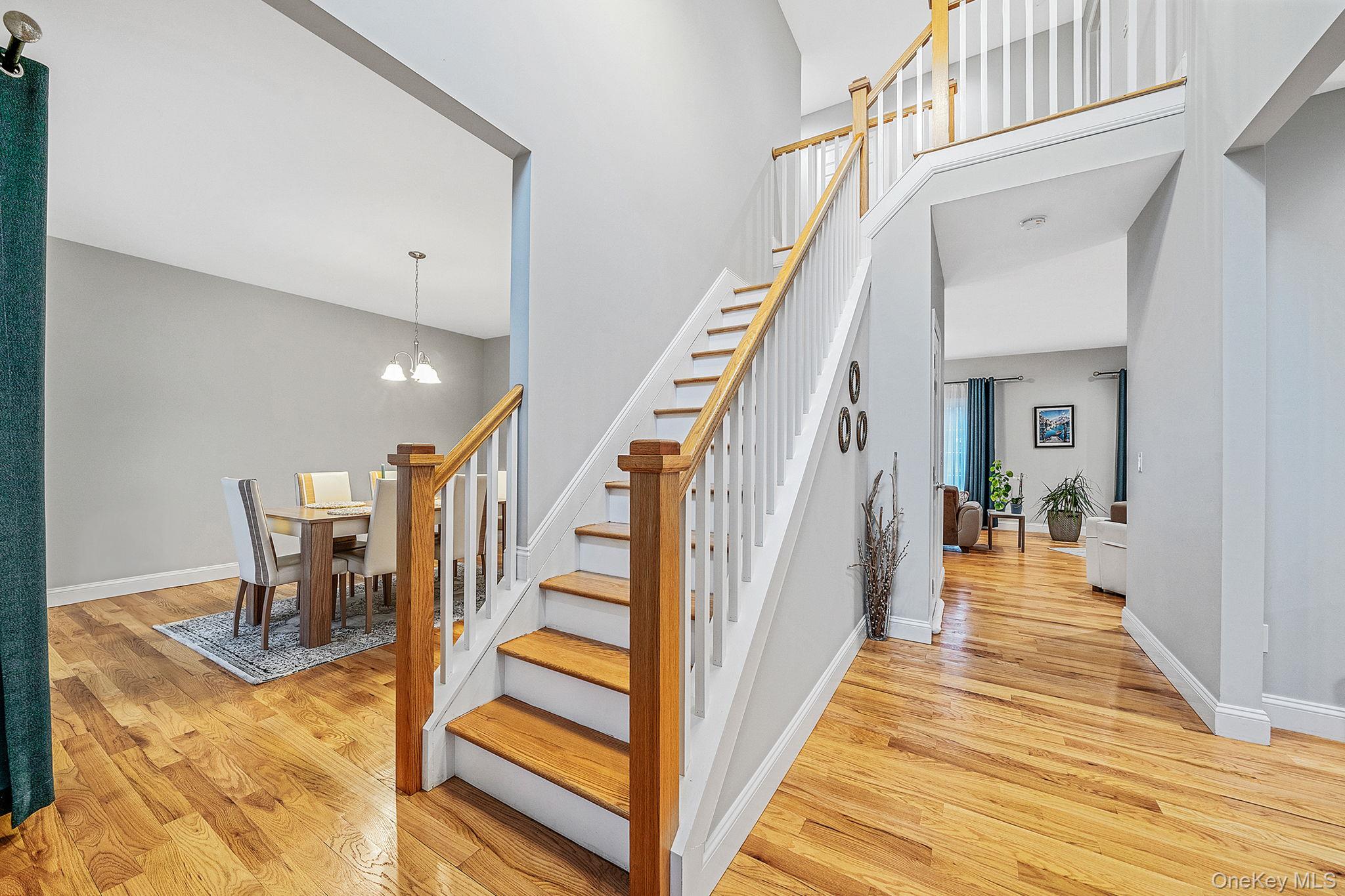 152 Wood Road Centereach, NY 11720 - Photo 4 of 35 a view of a hallway with wooden floor and staircase