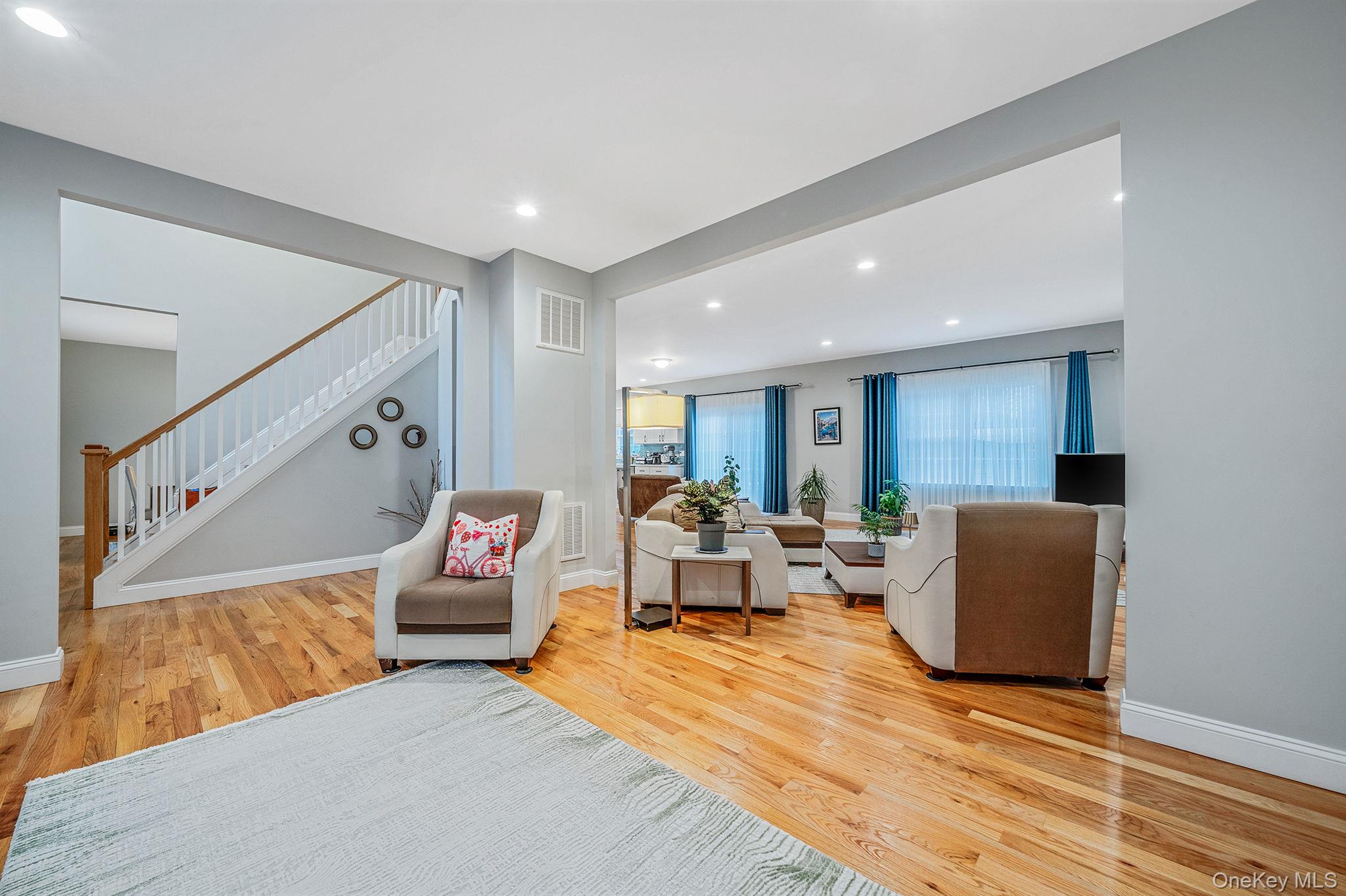 152 Wood Road Centereach, NY 11720 - Photo 7 of 35 a living room with furniture and a wooden floor
