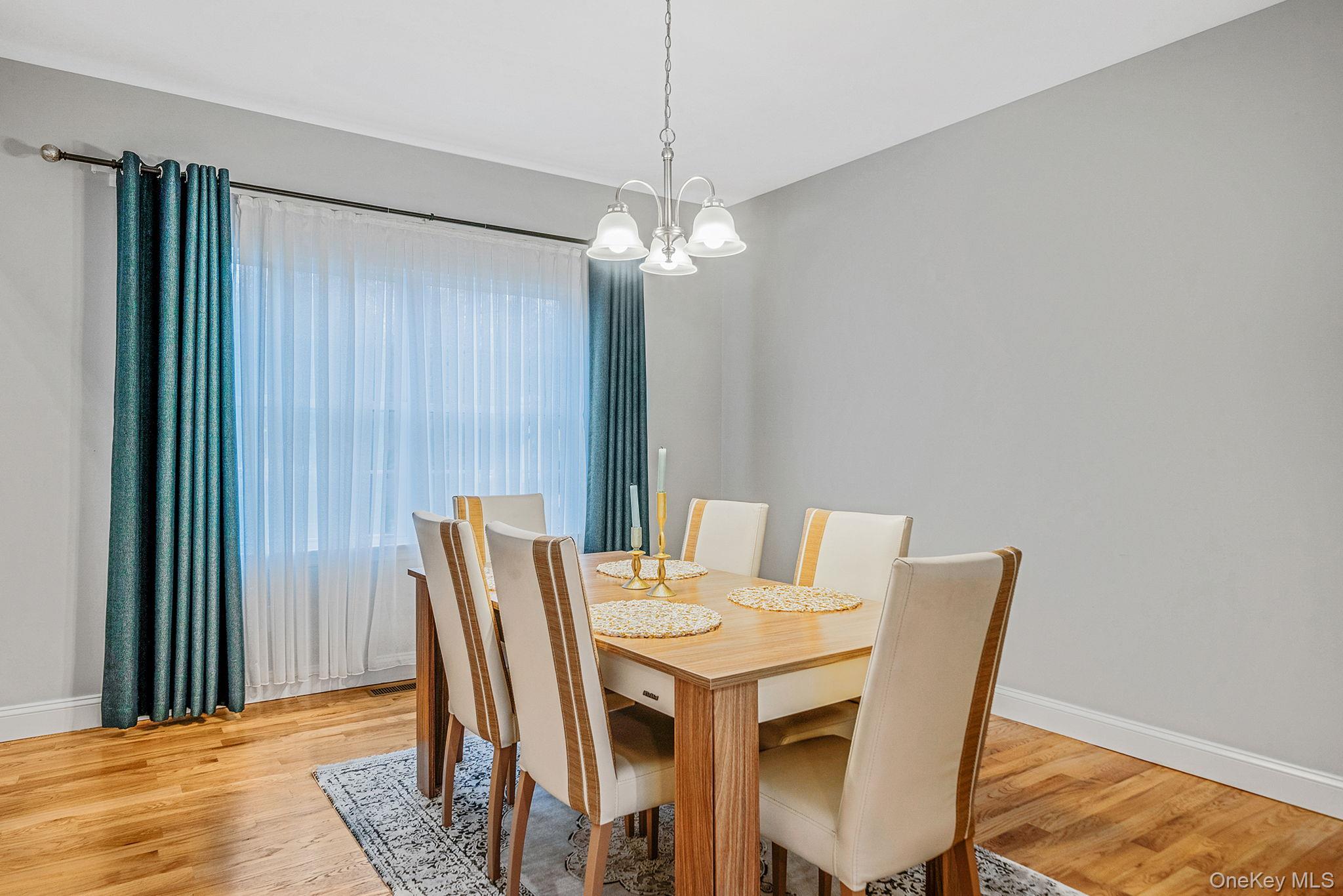 152 Wood Road Centereach, NY 11720 - Photo 8 of 35 a view of a dining room with furniture window and wooden floor