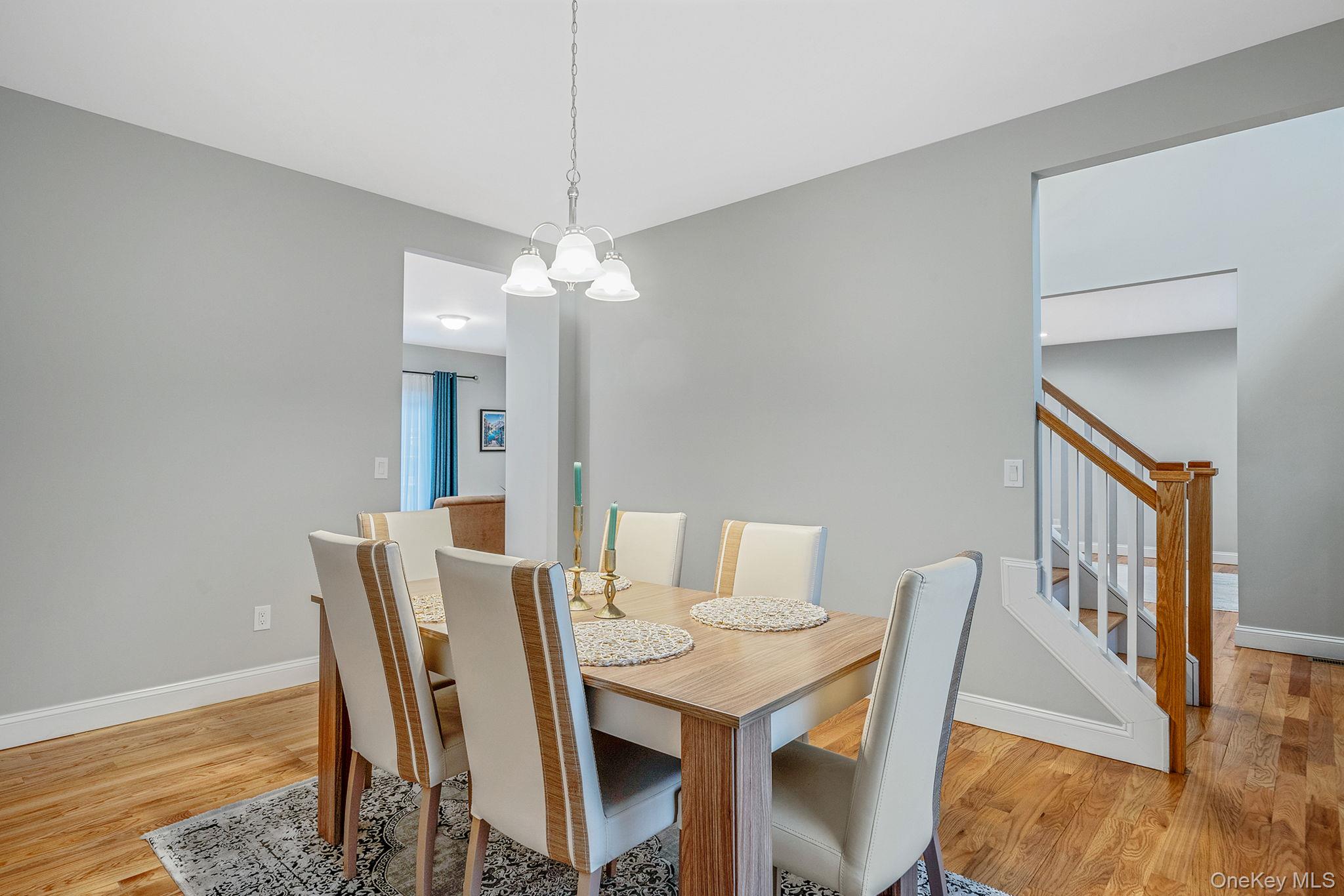 152 Wood Road Centereach, NY 11720 - Photo 9 of 35 a view of a dining room with furniture and wooden floor