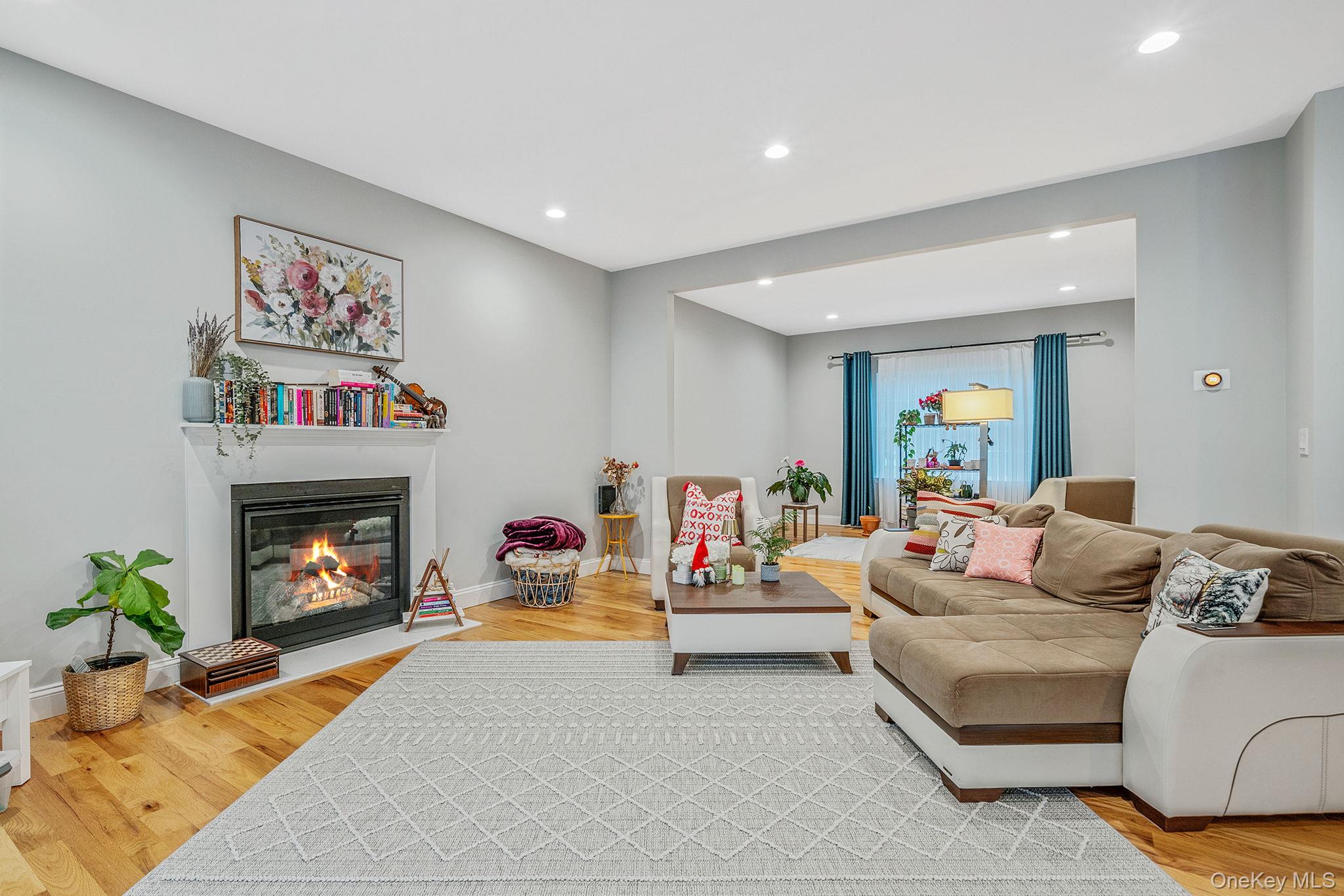 152 Wood Road Centereach, NY 11720 - Photo 10 of 35 a living room with furniture and a fireplace