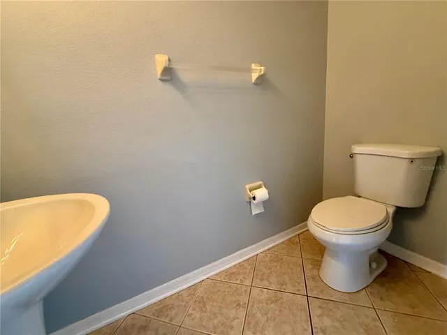 a bathroom with a toilet and a rug