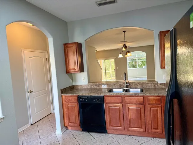 a bathroom with a granite countertop sink a two mirror a window and a mirror
