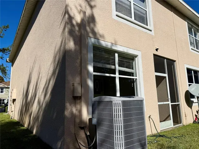 an empty room with a chandelier fan