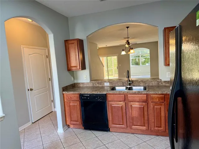 a kitchen with a sink and a refrigerator