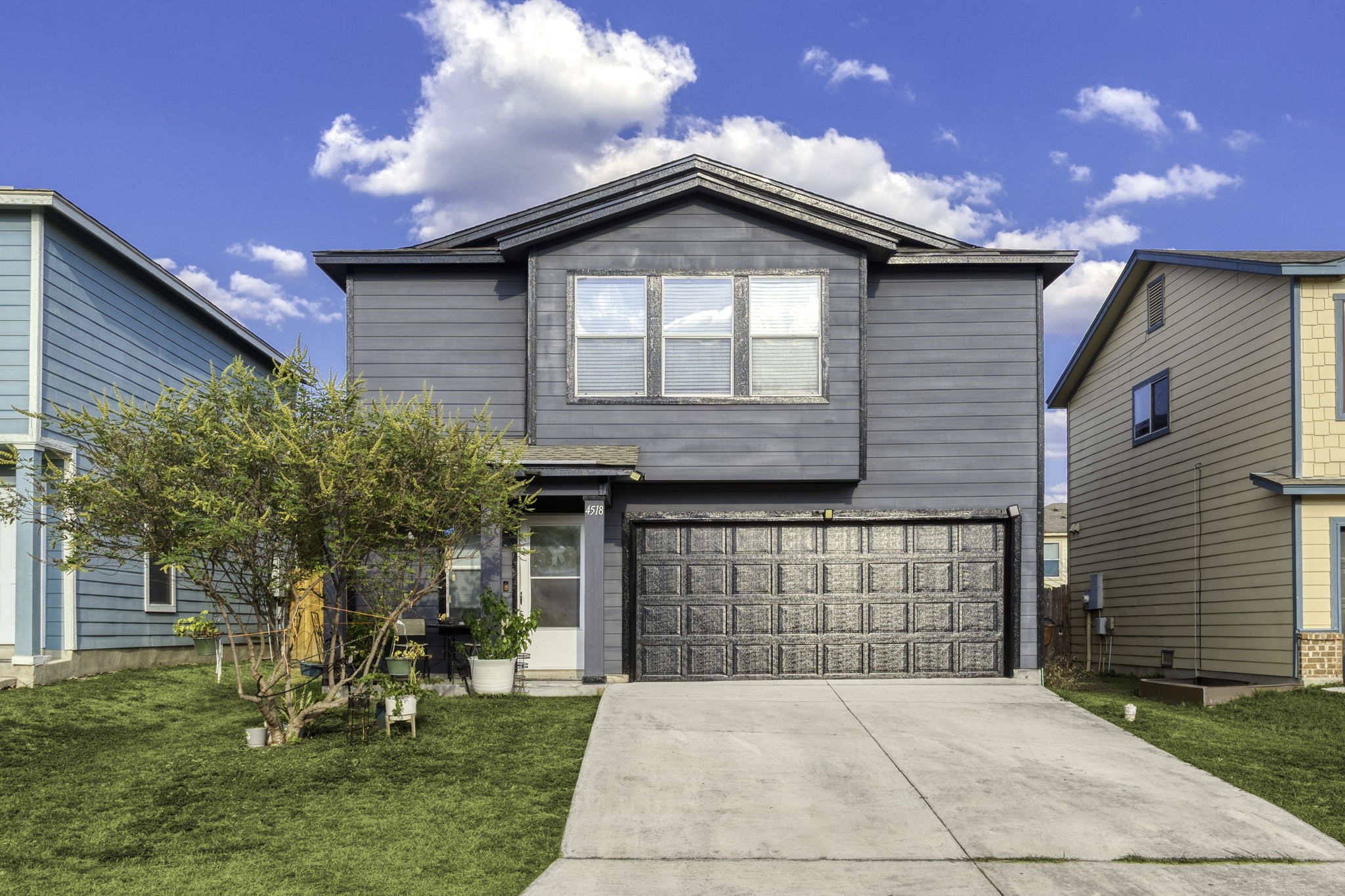 a front view of a house with a garden